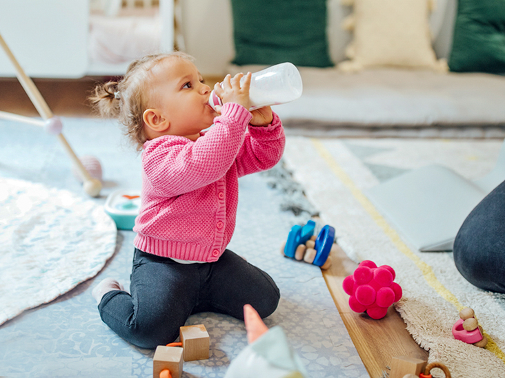 when do babies hold their own bottle